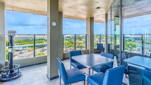 A modern restaurant with a view of a highway and cityscape. - Holiday Inn Miami - International Airport by IHG (Miami Springs)