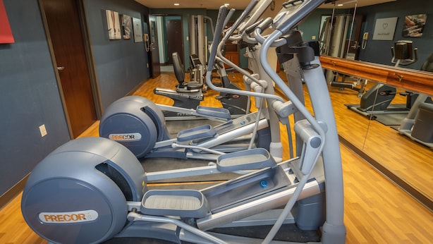 A gym with multiple exercise machines, including treadmills and elliptical trainers. - Comfort Suites Outlet Center (Asheville)