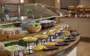 A buffet with various food items and a salad bar. - Hilton Milan (Milan)