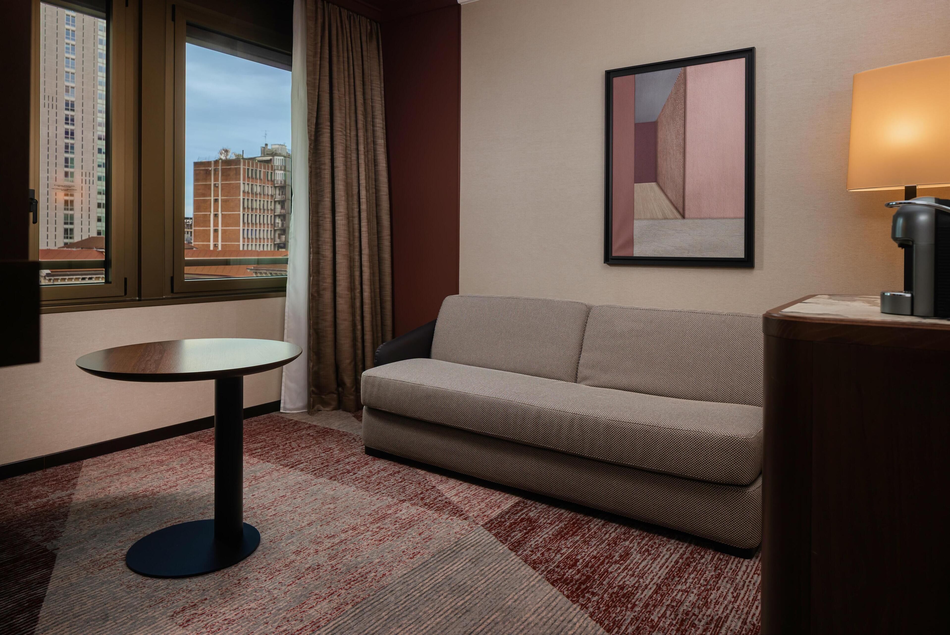 junior suite, 1 king bed | living area | 40-inch tv with satellite channels