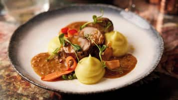 A plate of food with a variety of vegetables and a sauce.