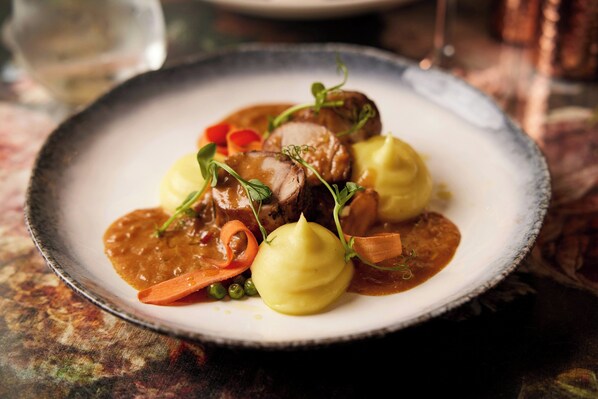 A plate of food with a variety of vegetables and a sauce. - The Clermont London, Charing Cross (London)
