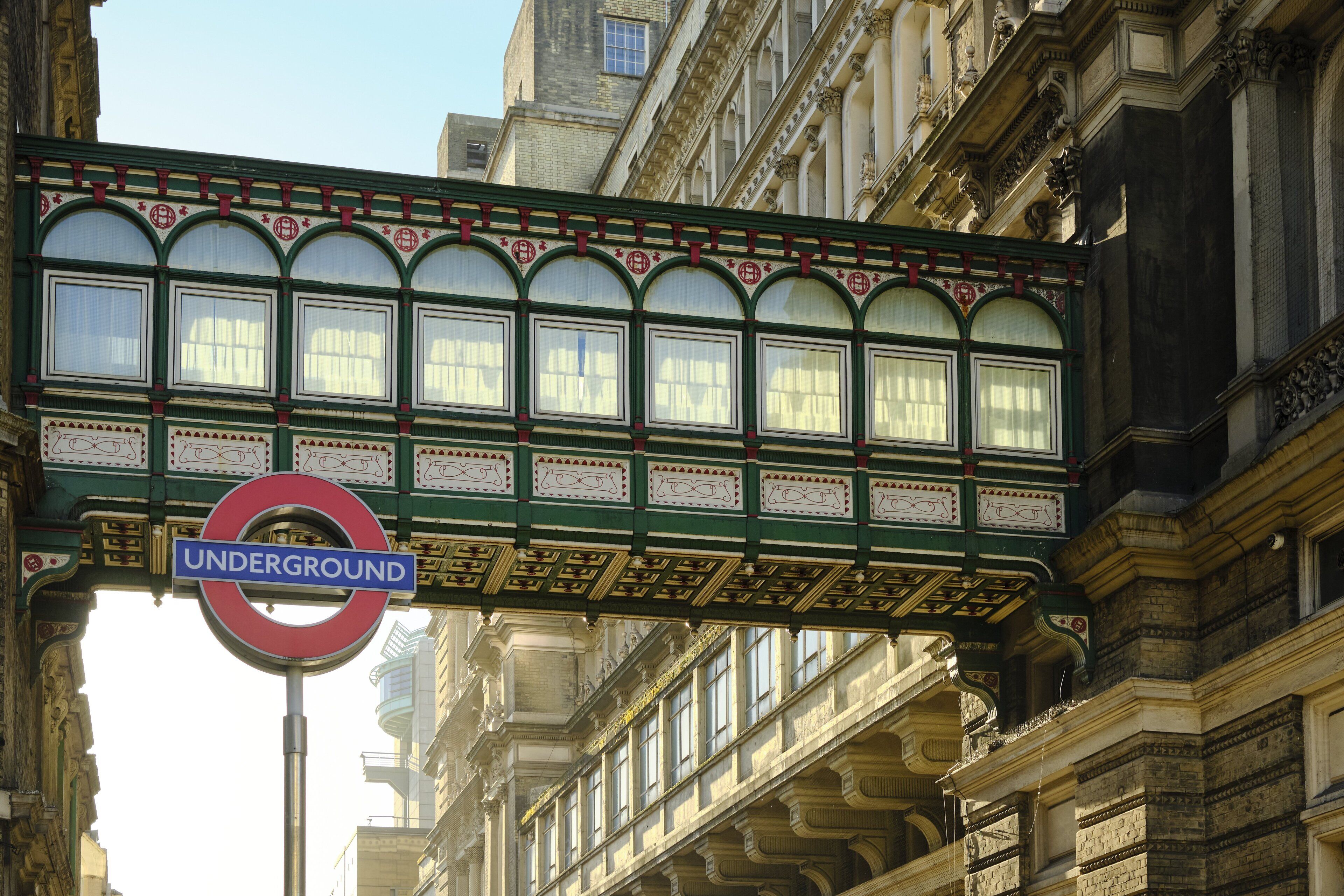 A historic building with ornate architectural details and a prominent 'Underground' sign.