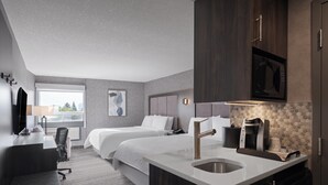 A modern hotel room with two beds, a desk, a chair, a sink, and a microwave.