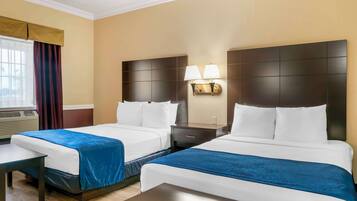 A hotel room with two beds, a nightstand with lamps, a window with curtains, and an air conditioning unit.