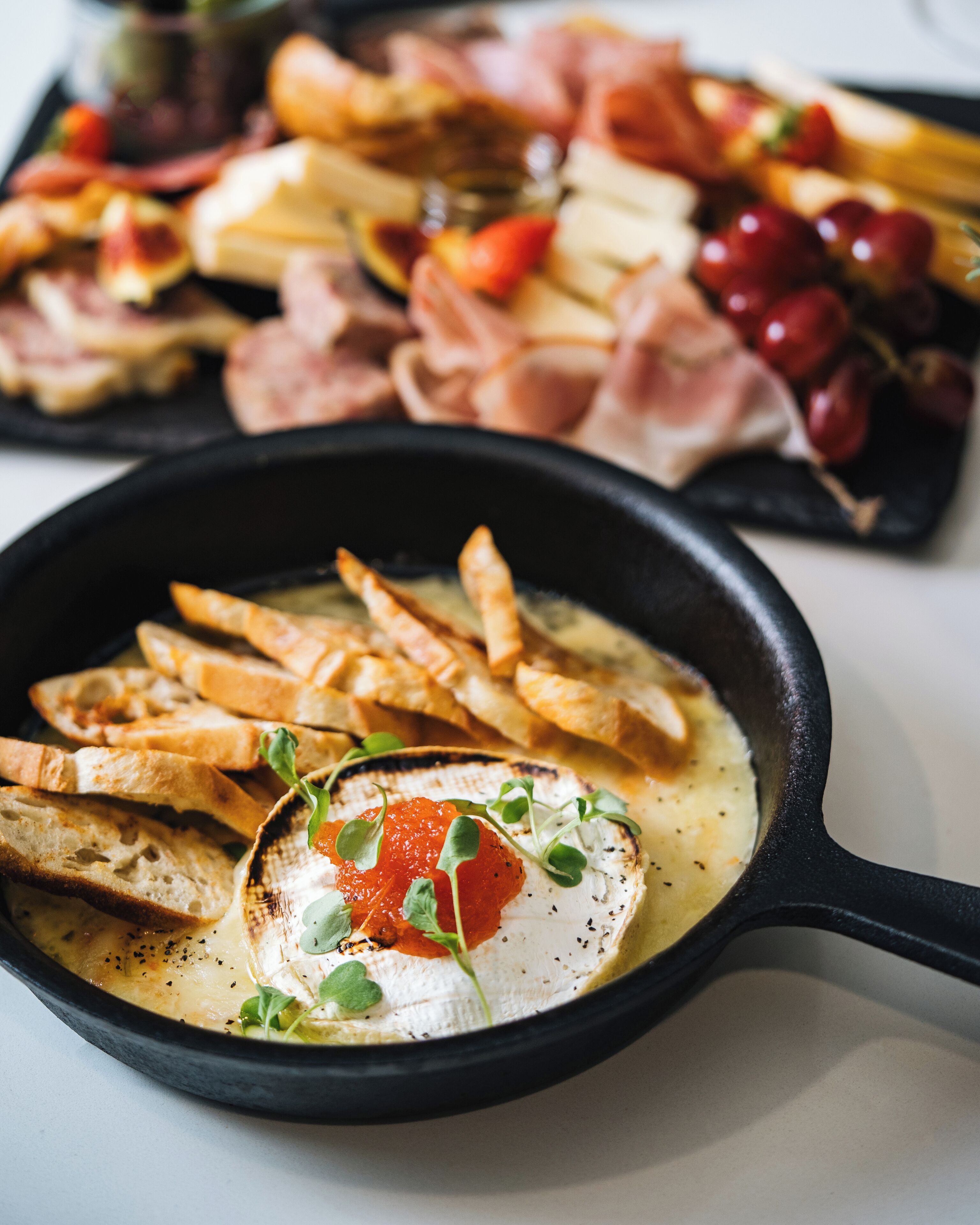 A skillet with bread and a poached egg.