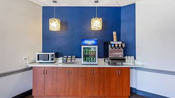 A reception area with a Dannon refrigerated display, a coffee machine, and a microwave.