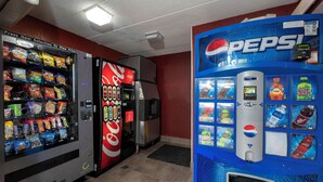 A vending machine area with a Pepsi dispenser and a variety of snack options. - Red Roof Inn Washington DC - Lanham (Lanham)