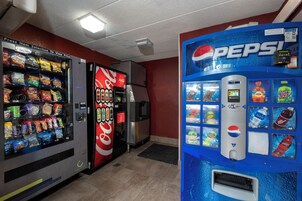 A vending machine area with a Pepsi dispenser and a variety of snack options.