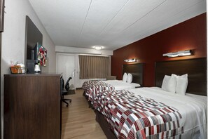 A hotel room with two beds, a desk, a TV, and a window with curtains. - Red Roof Inn Washington DC - Lanham (Lanham)