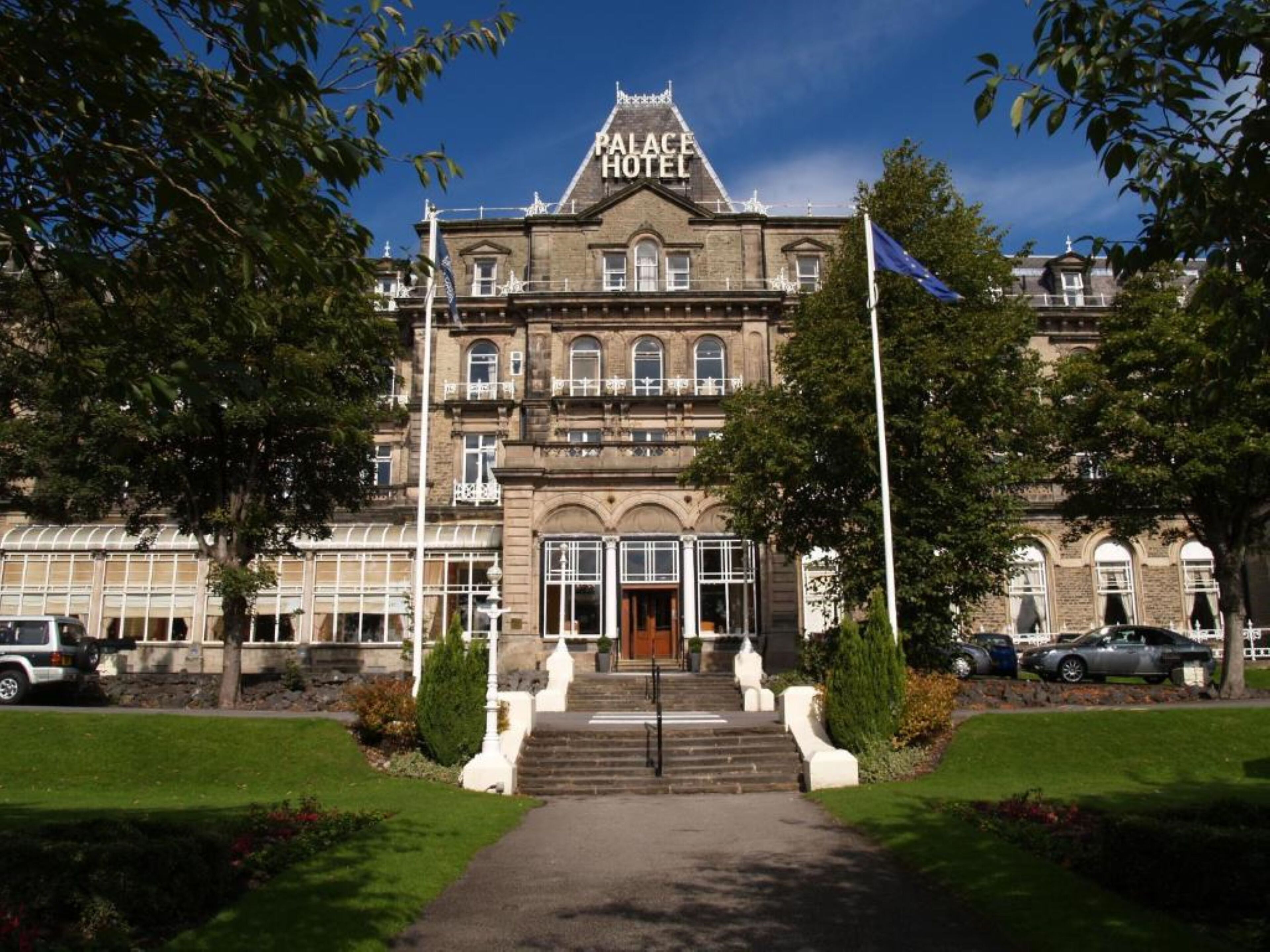 A historic building with a prominent sign reading "PALACE HOTEL".