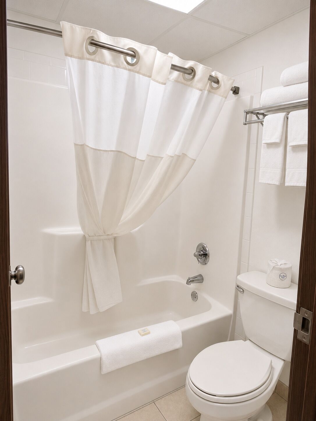 A bathroom with a bathtub, toilet, and shower curtain.