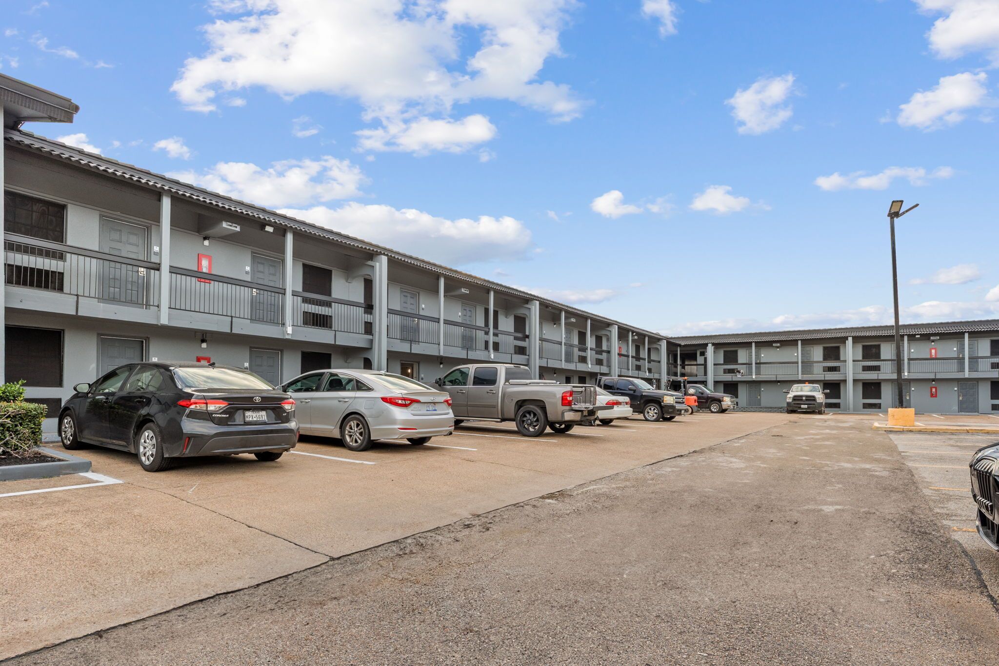A multi-story parking garage with several cars parked.