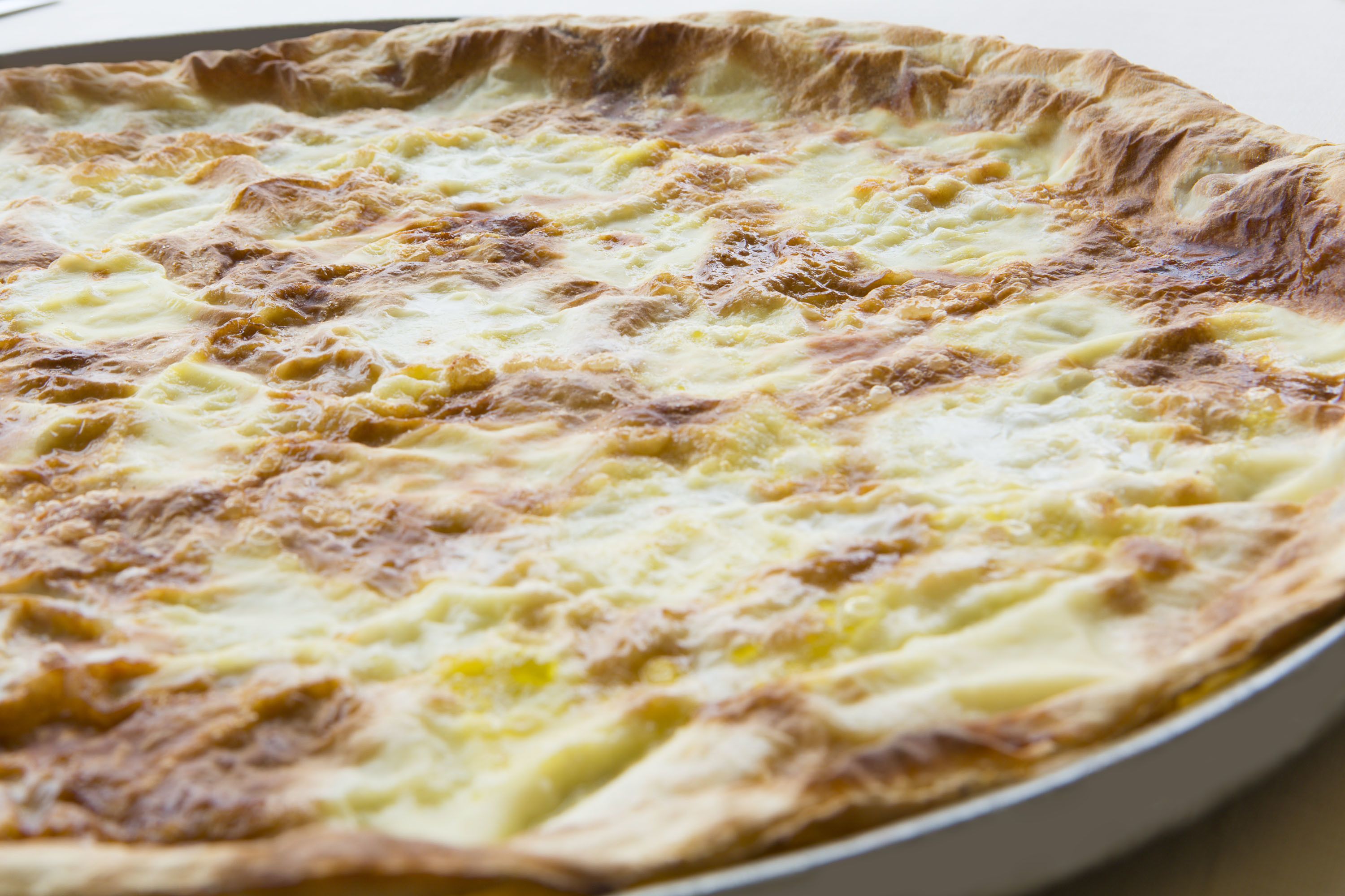 A round pie with a golden-brown crust and a creamy filling.