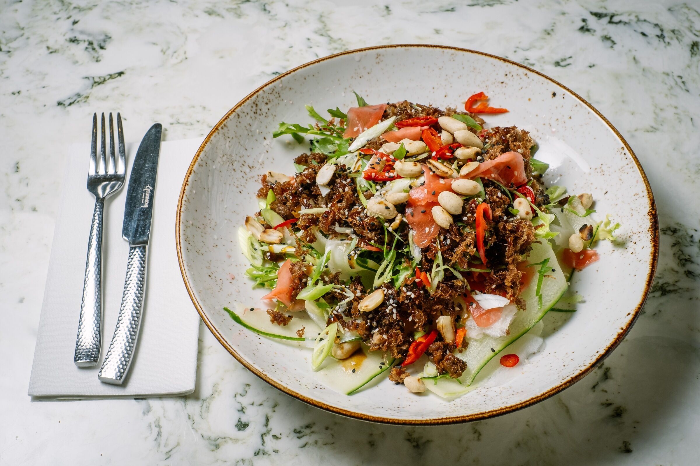 A plate of food with various toppings and garnishes.