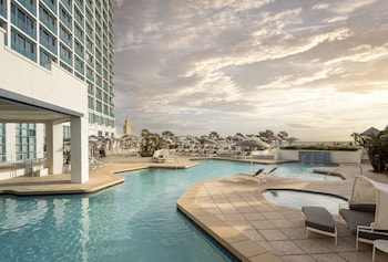 2 outdoor pools, pool umbrellas, sun loungers at Hilton Daytona Beach Oceanfront Resort