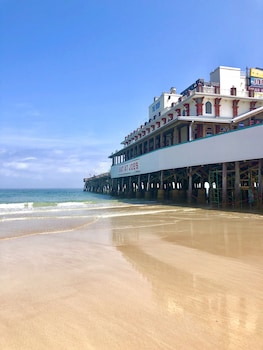On the beach, white sand, beach towels, windsurfing at Hilton Daytona Beach Oceanfront Resort