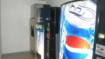 A vending machine area with a Dasani water dispenser and a Pepsi machine.