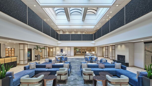 A spacious lobby with a high ceiling, seating areas, and a central open space. - Salt Lake Marriott Downtown at City Creek (Salt Lake City)