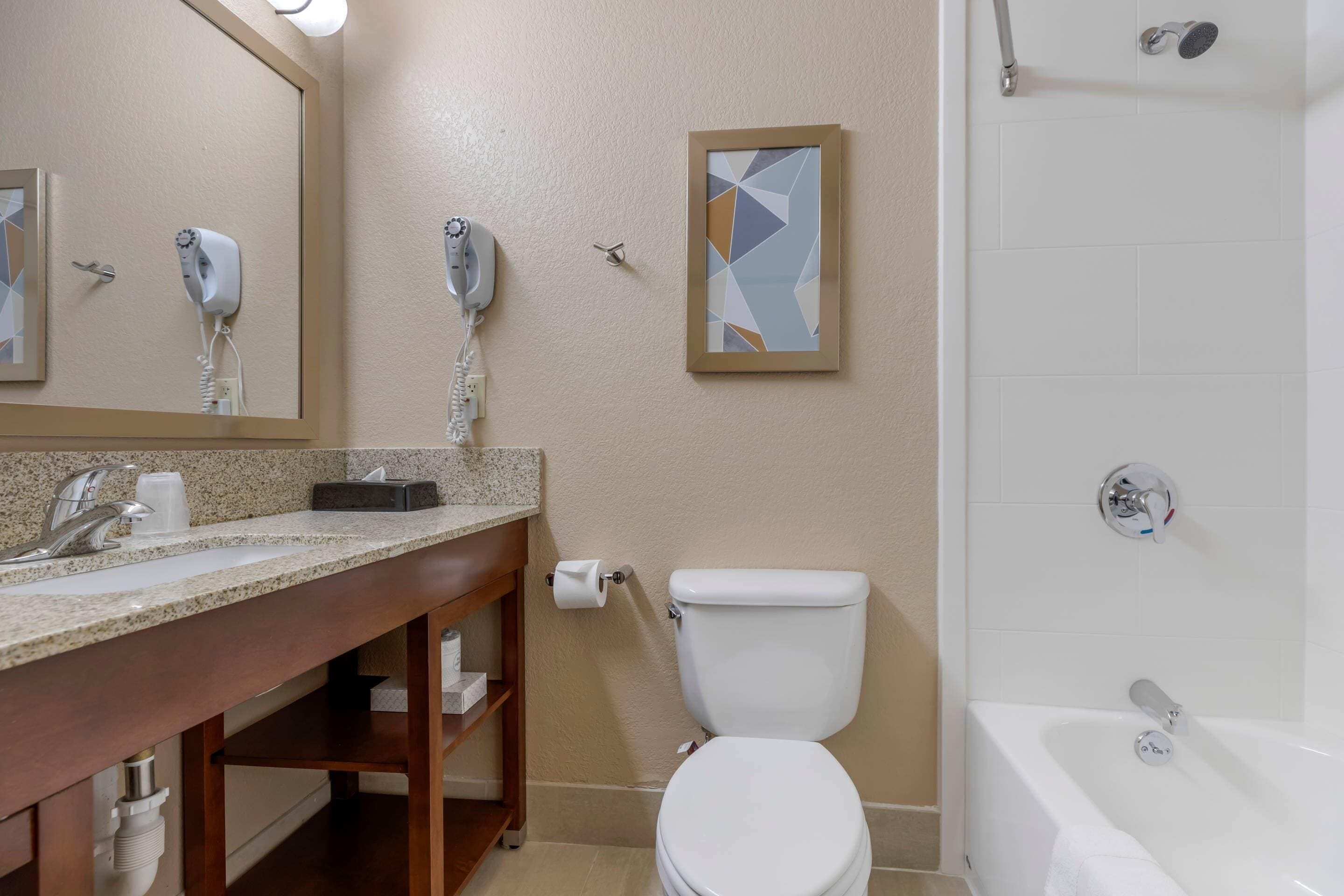 A bathroom with a sink, toilet, and bathtub.