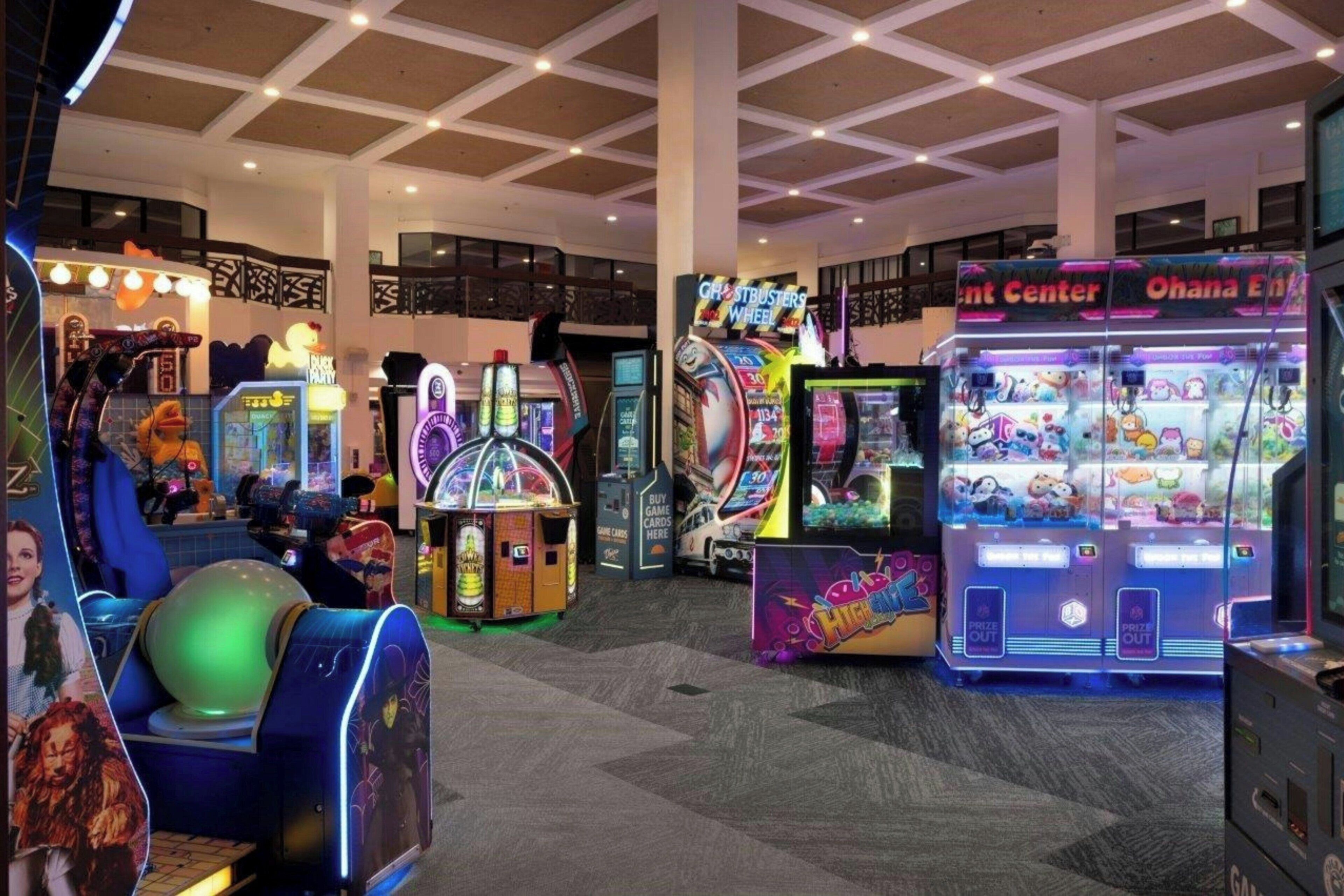 A gaming arcade with various machines and a claw machine.