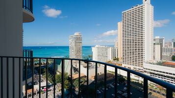 A high-rise hotel with a view of the ocean and other buildings.