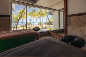 A high-rise hotel with multiple floors, a pool, and a view of the ocean. at Waikiki Beach Marriott Resort & Spa
