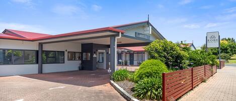 A motel with a red roof, a covered reception area, and a sign indicating it is the Robe Central Hotel.