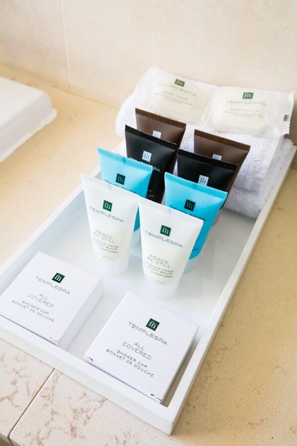 A tray with various Templespa products, including a covered shower cap and a bonnet de douche.