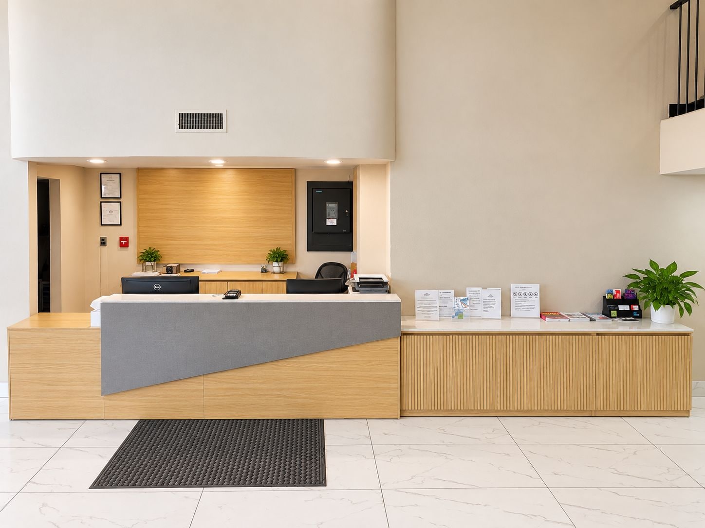 A reception desk with a modern design, a plant, and informational brochures.