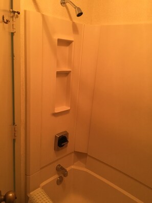 A bathroom with a shower, a toilet, and a sink.