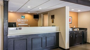 A reception desk with a sign reading "Quality Inn by Choice Hotels." - Quality Inn Hartsville (Hartsville)