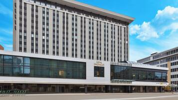A modern hotel building with a prominent sign for 'Hotel Indigo.'