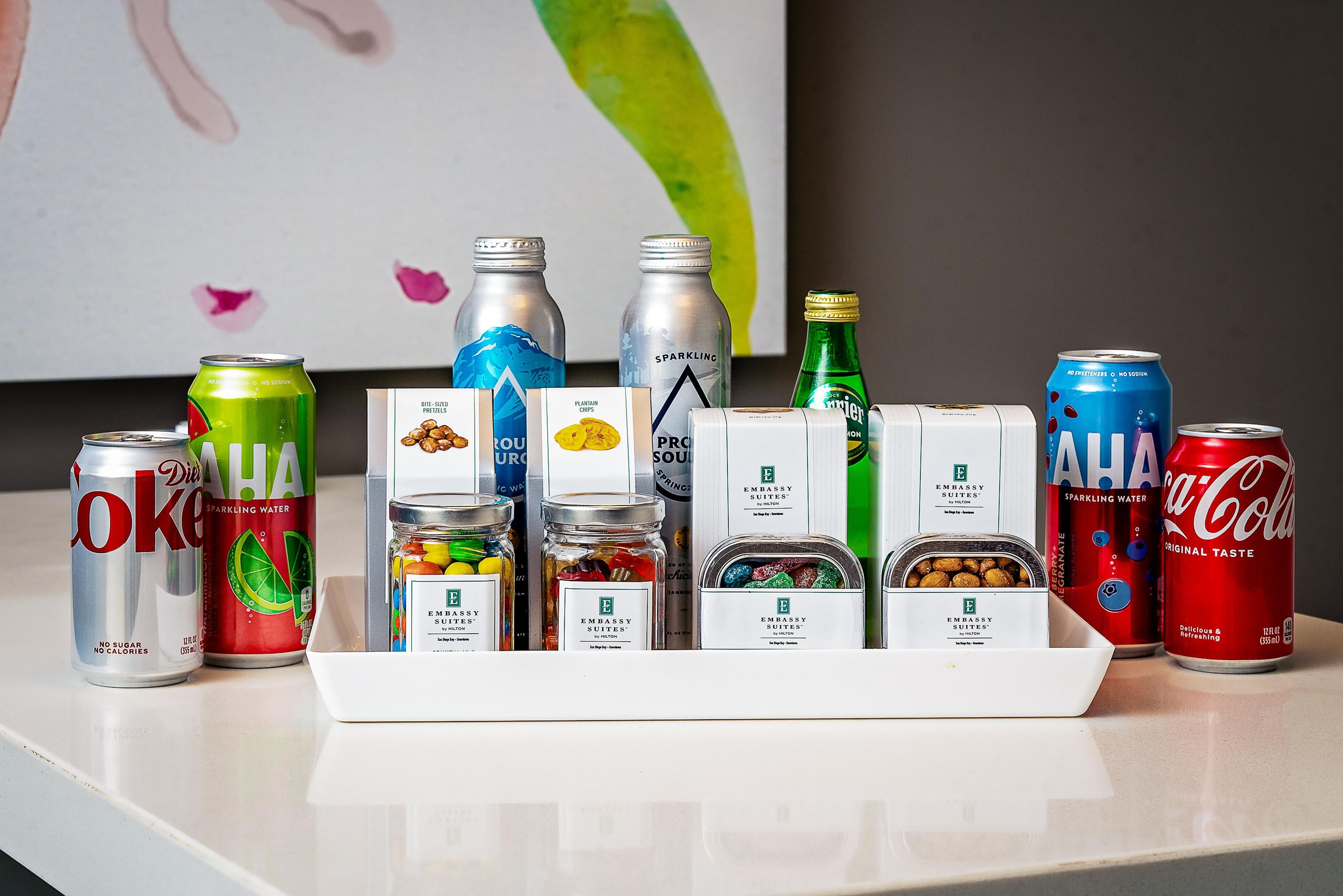 A variety of beverages and snacks arranged on a tray.