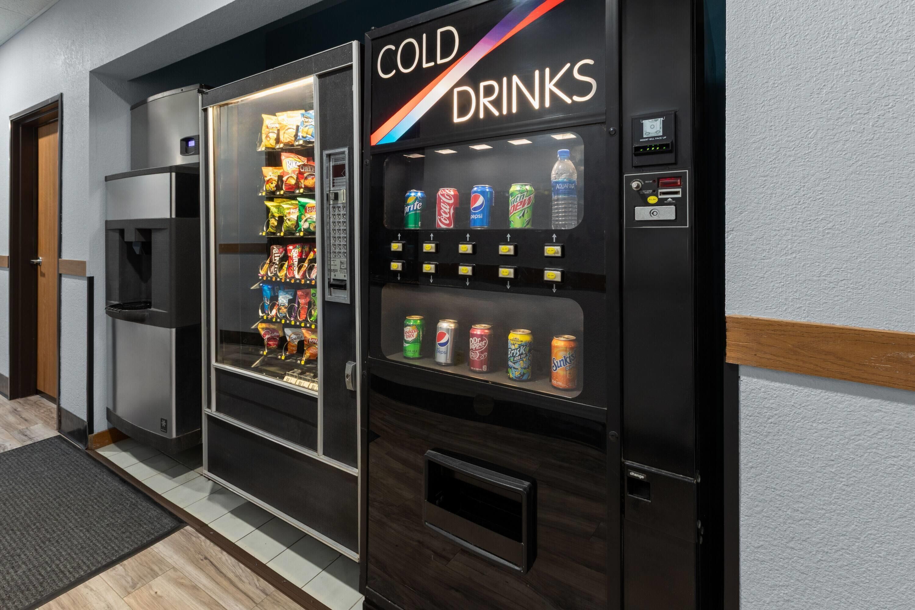 A vending machine labeled 'COLD DRINKS' with various beverages and snacks inside.