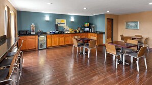 A breakfast area with wooden cabinets, a coffee machine, and a sign for Daybreak Breakfast. - Days Inn by Wyndham Glasgow (Glasgow)