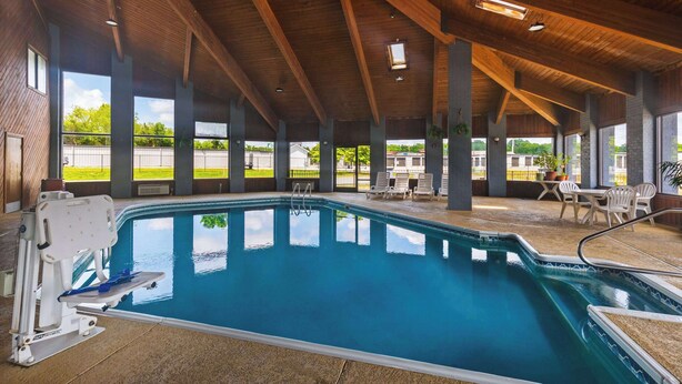 An indoor swimming pool with a wooden ceiling and large windows. - Days Inn by Wyndham Glasgow (Glasgow)