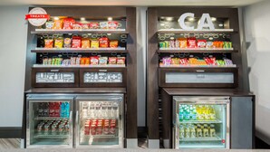 A snack and beverage display with various packaged snacks and drinks. - Hampton Inn Monterey (Monterey)