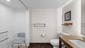 A modern bathroom with a shower, toilet, and sink.