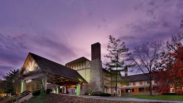 Hotel features a distinctive architectural style with a prominent chimney and overhanging roof.