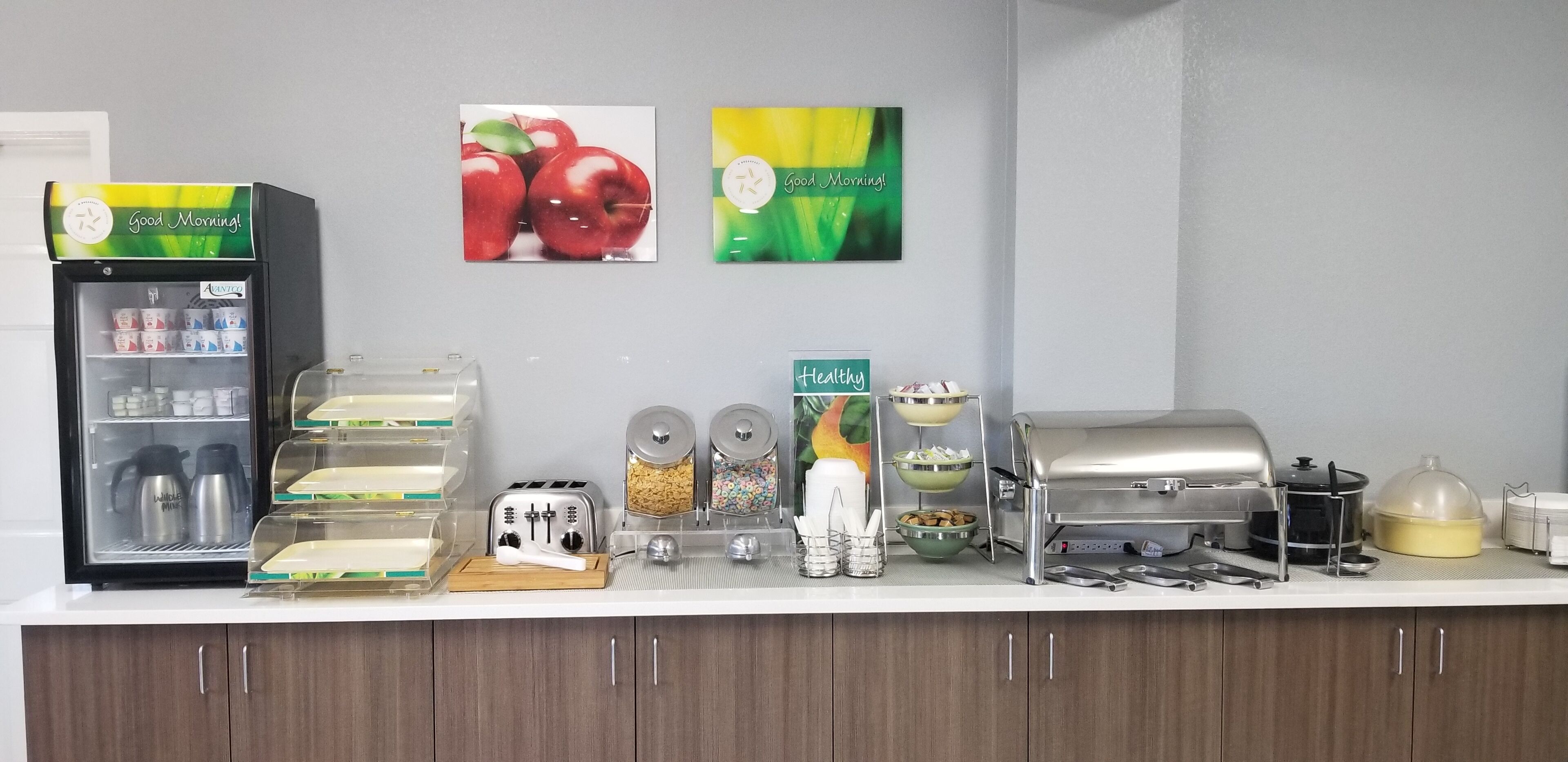 A kitchen counter with a coffee machine, toaster, and various food containers.