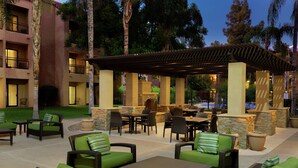 An outdoor patio area with seating, a bar, and a covered section.