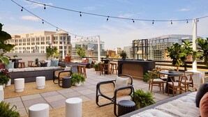 A rooftop terrace with seating areas, tables, and potted plants. - The Westin DC Downtown (Washington)