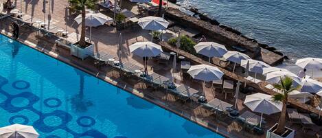 Seasonal outdoor pool, open 9:00 AM to 7:00 PM, pool umbrellas