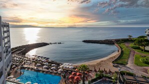 A resort with a swimming pool, beach, and ocean view. - Pullman Cannes Mandelieu (Mandelieu-La-Napoule)