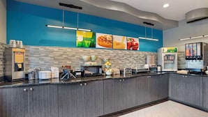 A modern kitchen area with a waffle station, microwave, toaster, and a refrigerator. - Quality Inn & Suites Birmingham - Highway 280 (Birmingham)