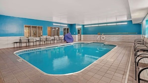 An indoor swimming pool with tiled flooring, a blue and white color scheme, and several lounge chairs around the pool area. - Quality Inn & Suites Birmingham - Highway 280 (Birmingham)