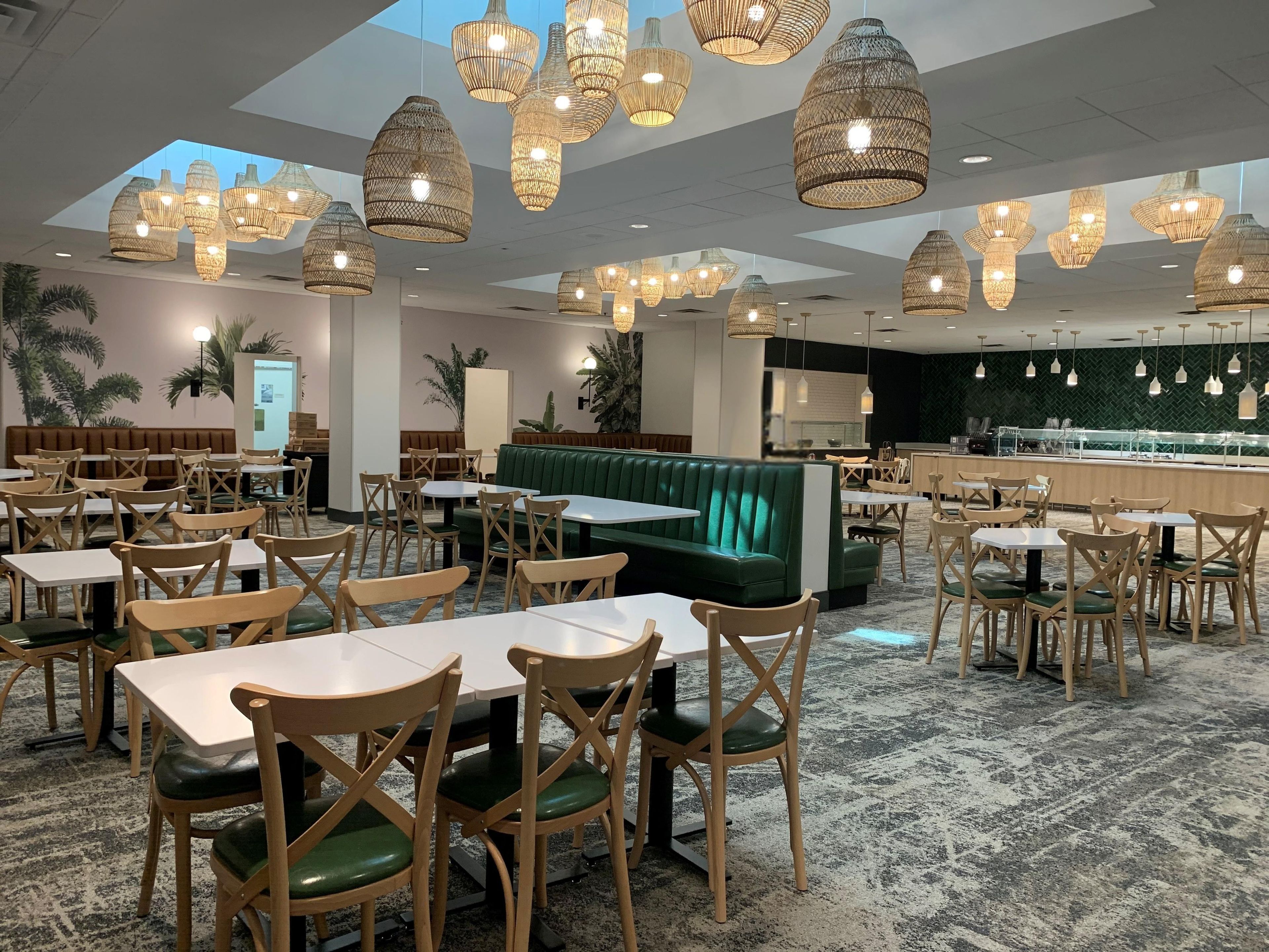 A restaurant with multiple seating areas, including booths and tables, and a bar area with a counter.