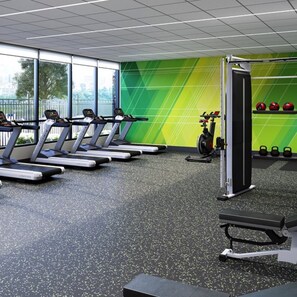 A gym with treadmills, a stationary bike, and a squat rack. - Holiday Inn Lansdale - Hatfield by IHG (Harleysville)