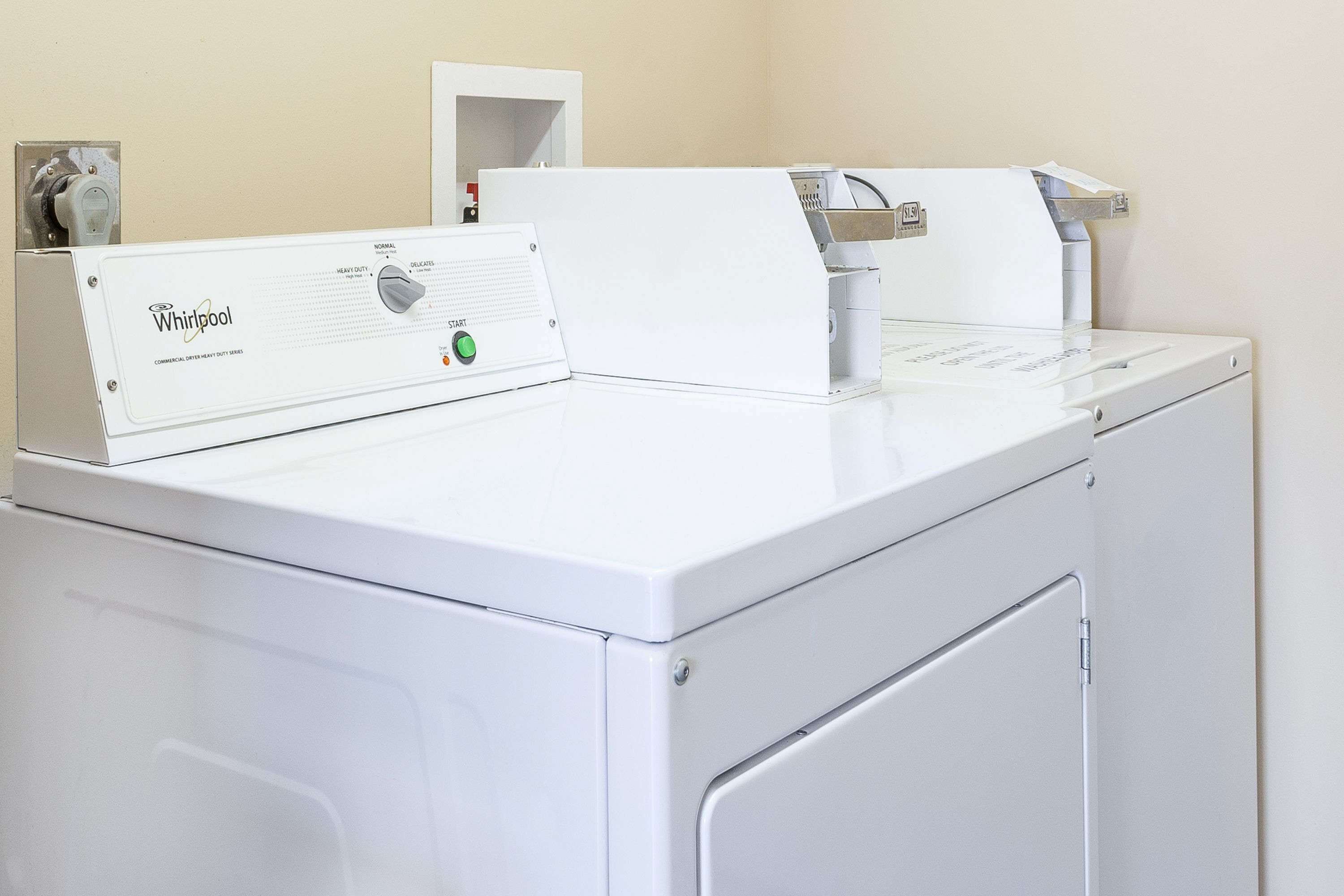 A front-loading Whirlpool washer and dryer unit in a laundry room.